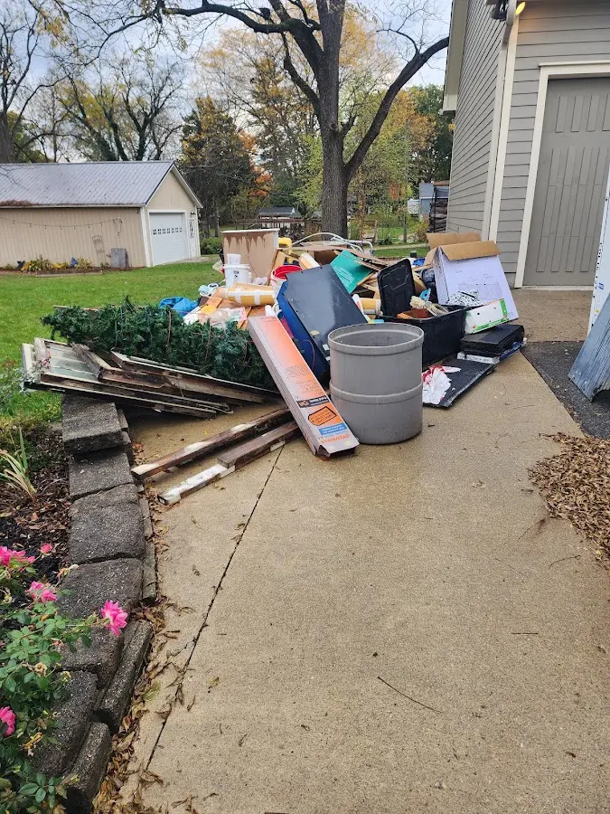 Dumpster being loaded with debris for Roofing Dumpster Rental in Waxhaw